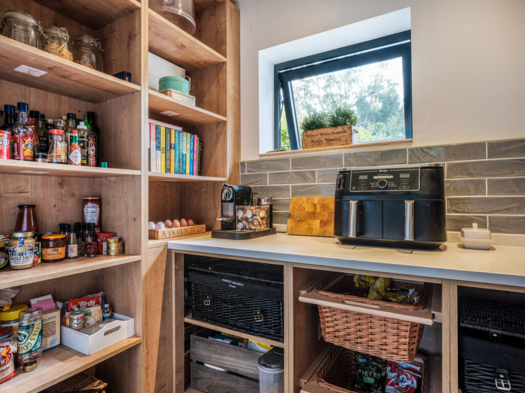 Contemporary modern kitchen pantry with appliance and shelving.