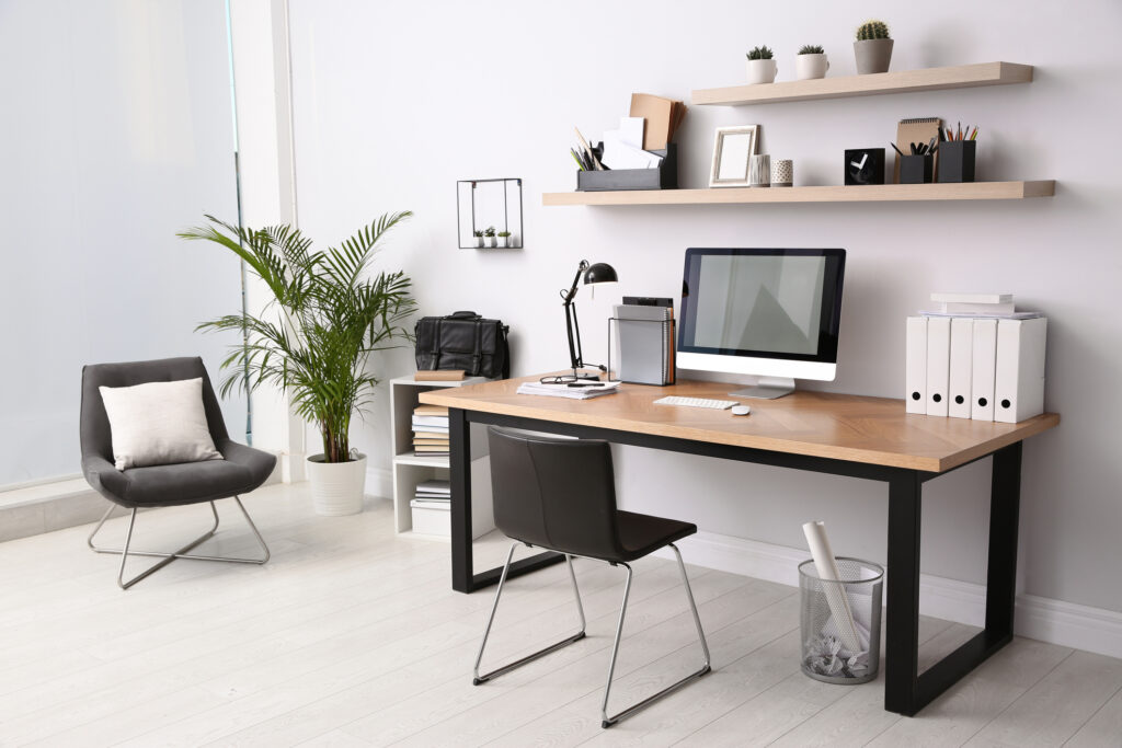 Home office interior with a desk, shelves, and decorations. A cozy and well-organized space to work.
